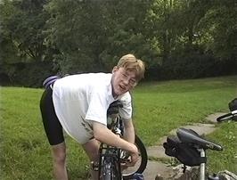 Oliver kindly lubricates Ryan's brakes in the peaceful gardens of Dentdale youth hostel
